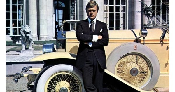 alt="Robert Redford in front of a yellow classic car filming The Great Gatsby in Newport, Rhode Island."