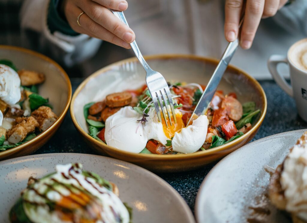 A picture of a diner cutting into an egg at brunch in Newport, Rhode Island. 