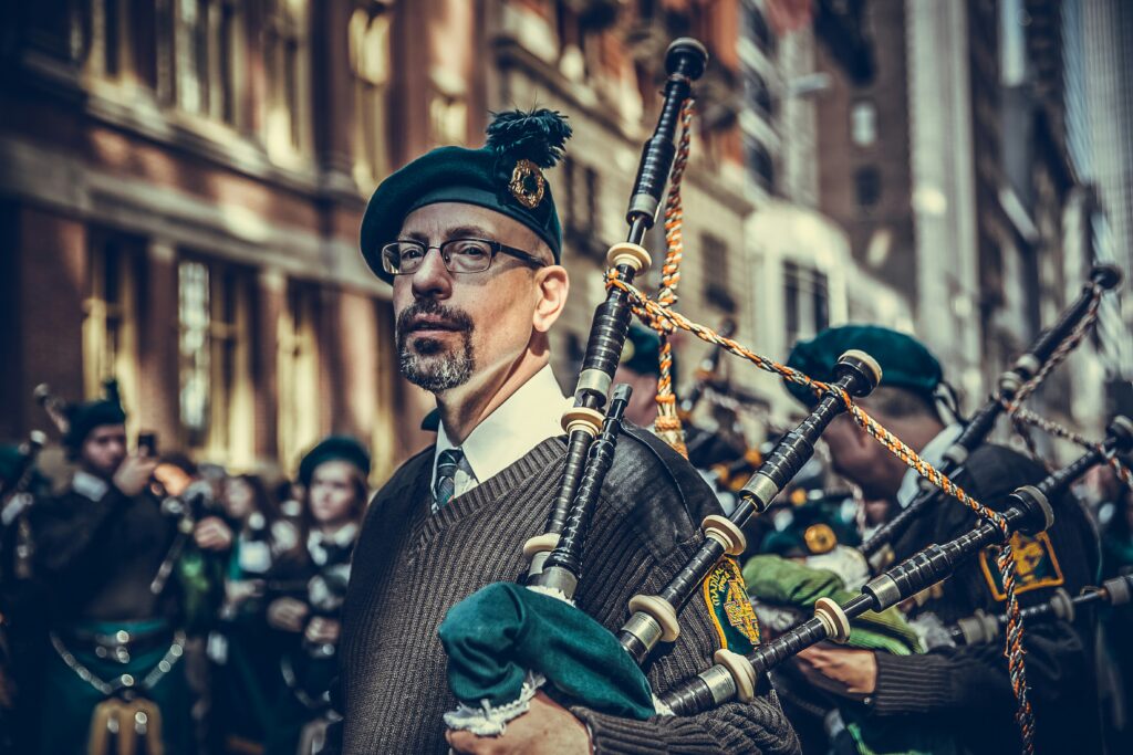A photo of a bagpiper in a St. Patrick's Day Parade. 