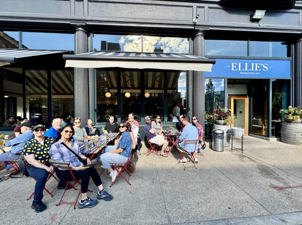 The Providence food tour siting in cafe chairs at Ellie's cafe in Rhode Island.