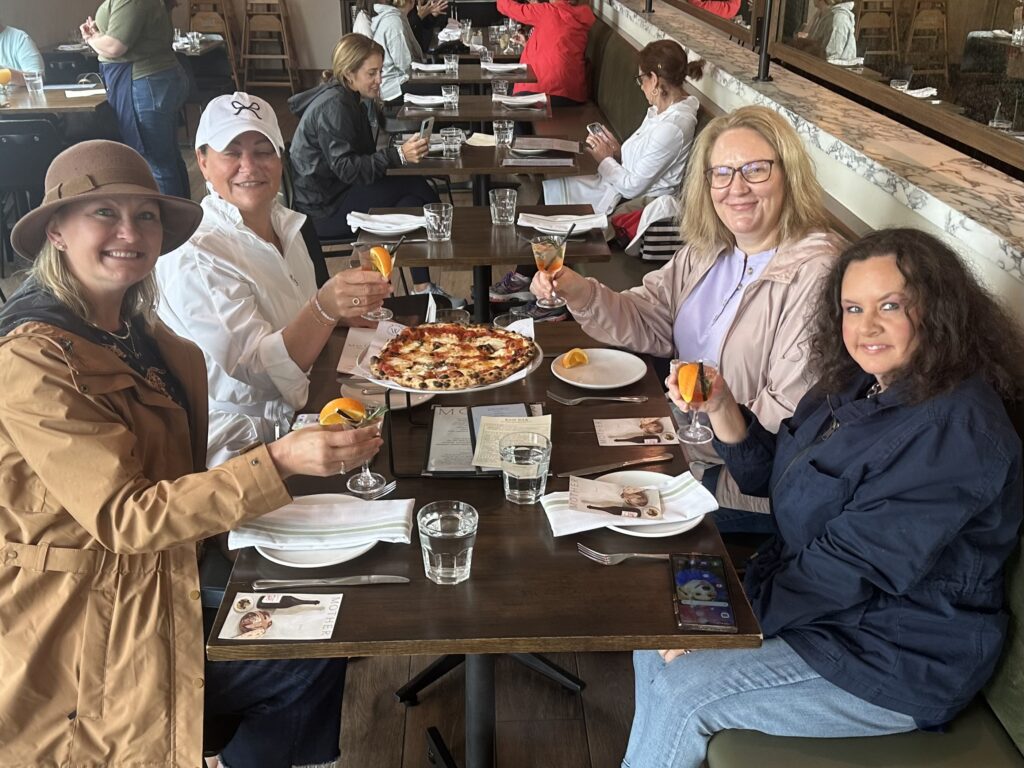 Women enjoying pizza ay Mother Pizzeria in Newport, Rhode Island!