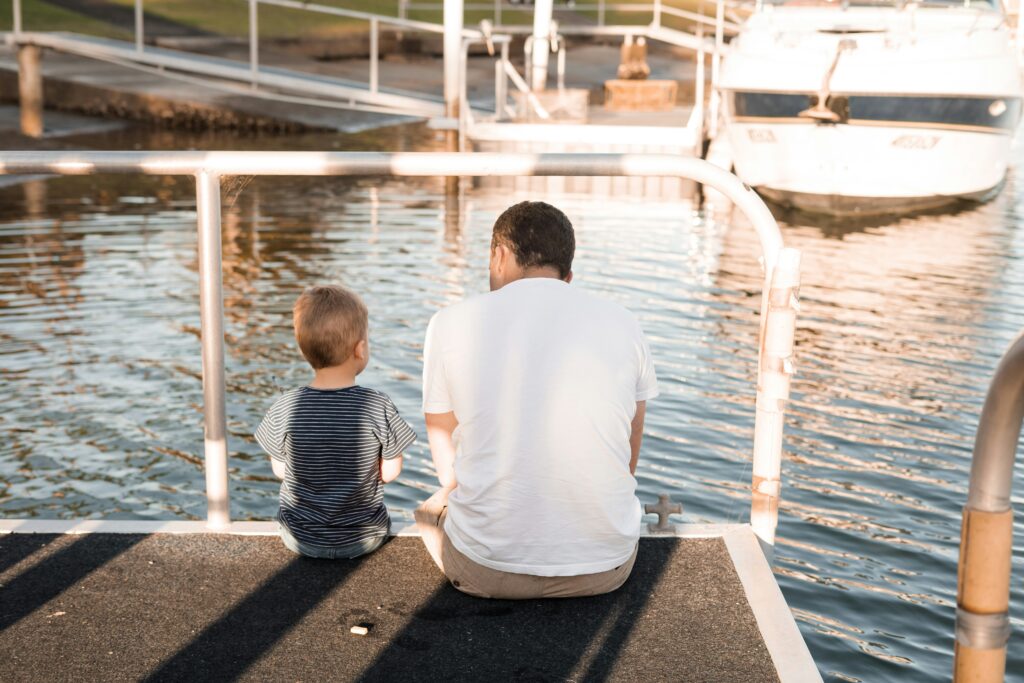 A photo of a father and young son on a dock in Rhode Island.